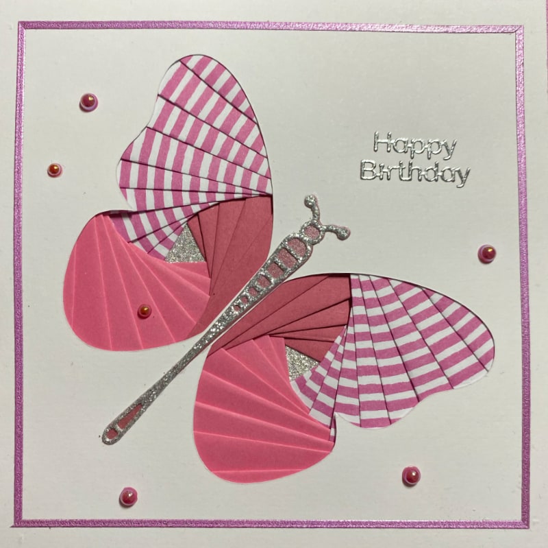 Pink iris-folded butterfly on a handmade birthday card